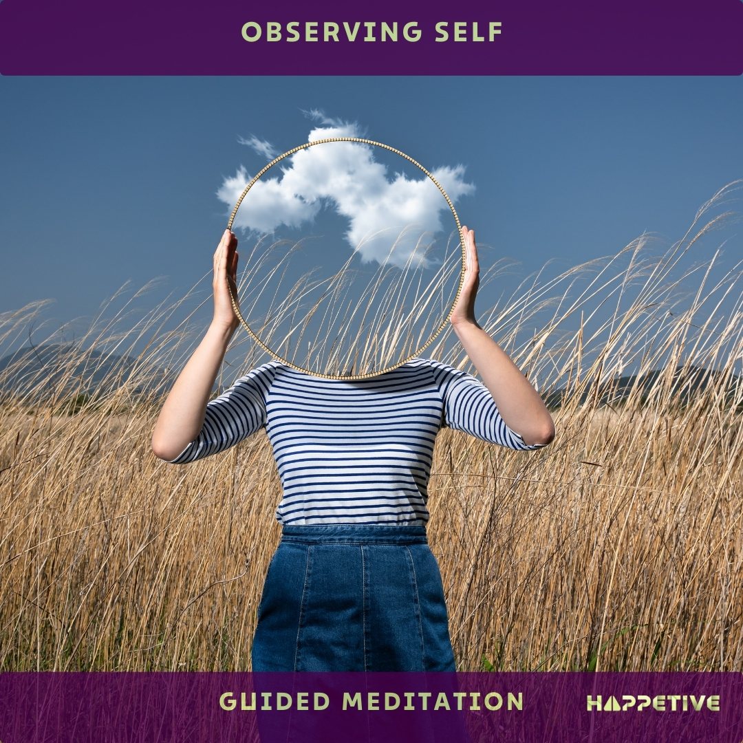 A women holding a glass mirror in front of her face in the grass fields and preparing for observing self guided meditation - Happetive.